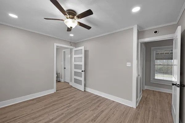 a view of an empty room with wooden floor