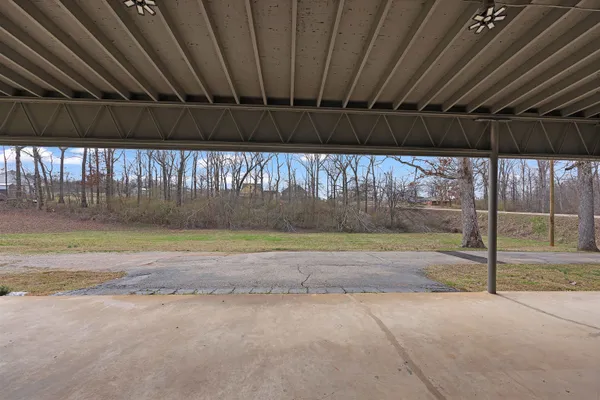 a view of a backyard with wooden fence