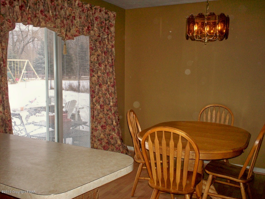 1111 Griffin Road Moscow, PA 18444 - Photo 3 of 8 a view of a dining room with furniture and wooden floor