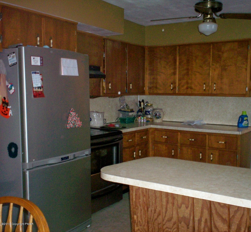 1111 Griffin Road Moscow, PA 18444 - Photo 4 of 8 a kitchen with a sink and cabinets