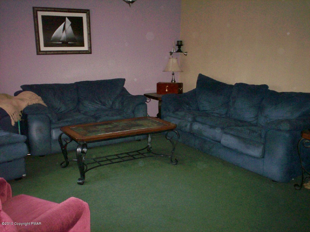 1111 Griffin Road Moscow, PA 18444 - Photo 6 of 8 a living room with furniture and a rug