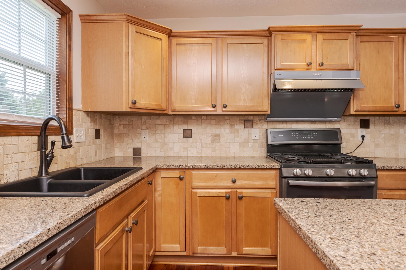 3250 Topaz Road Normal, IL 61761 - Photo 21 of 54 a kitchen with granite countertop a sink a stove and cabinets