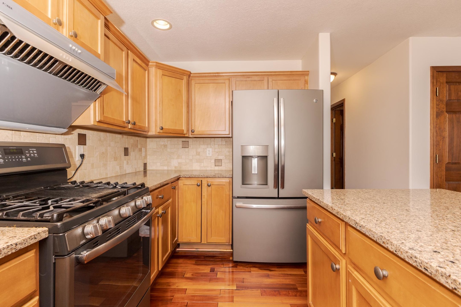 3250 Topaz Road Normal, IL 61761 - Photo 23 of 54 a kitchen with stainless steel appliances a refrigerator a sink and wooden cabinets