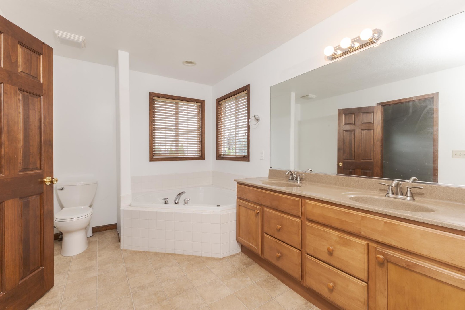 3250 Topaz Road Normal, IL 61761 - Photo 28 of 54 a spacious bathroom with a double vanity sink a mirror and a bathtub