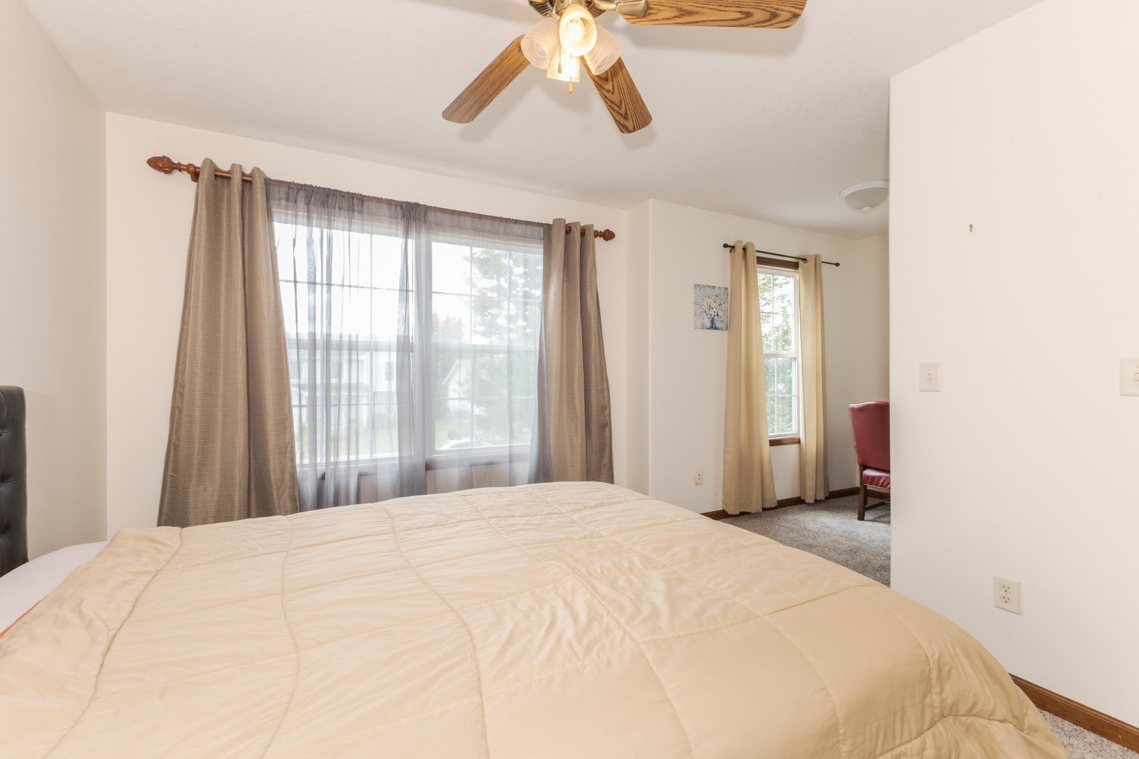 3250 Topaz Road Normal, IL 61761 - Photo 37 of 54 a bedroom with a large bed and a chandelier