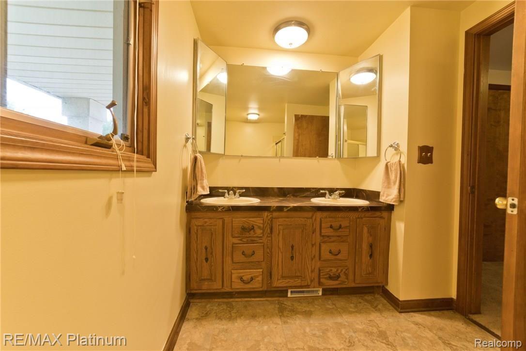 21706 Ruth Street Farmington, MI 48336 - Photo 24 of 32 Upstairs bathroom with dual sinks
