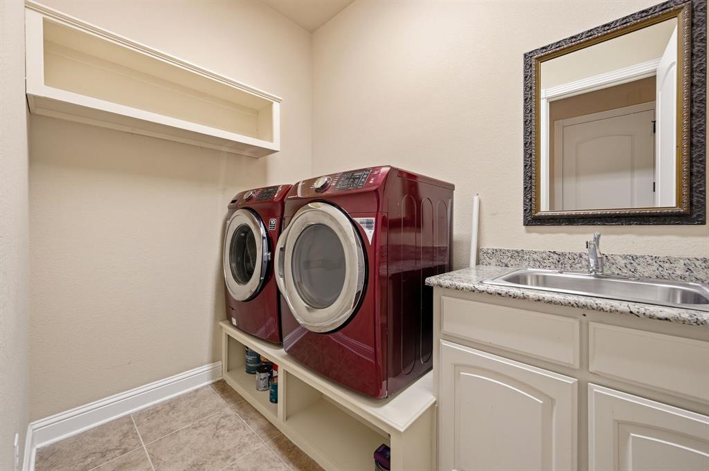 7013 Handel Colleyville, TX 76034 - Photo 29 of 37 Utility room featuring tiled flooring, a built-in sink with a countertop, white cabinetry, and an overhead storage shelf