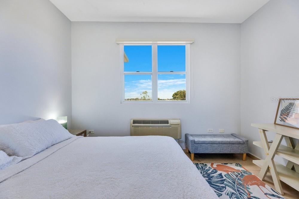413 Camino Carretas, Unit A7 Rincon, Rincón 00677 - Photo 12 of 23 a bedroom with a bed and a window