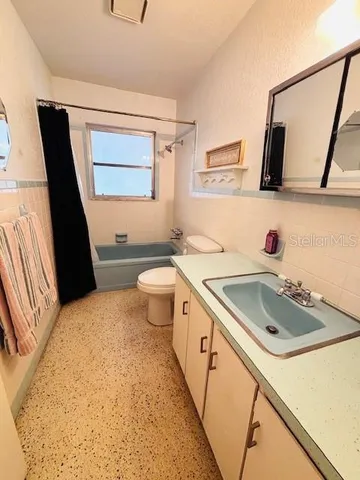 a bathroom with a sink toilet and mirror