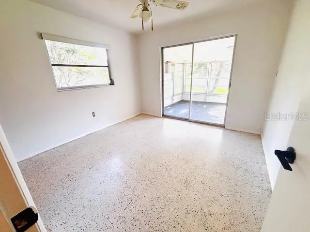 an empty room with windows and closet