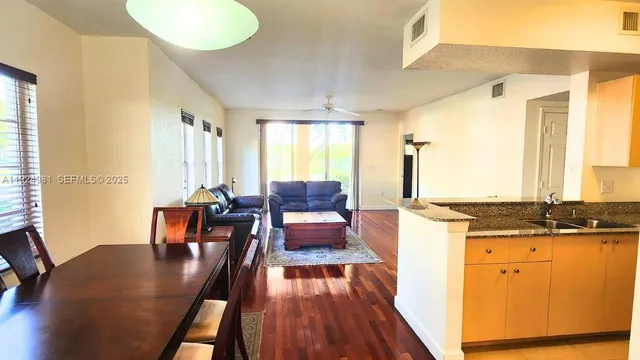 a view of a dining room with furniture and wooden floor