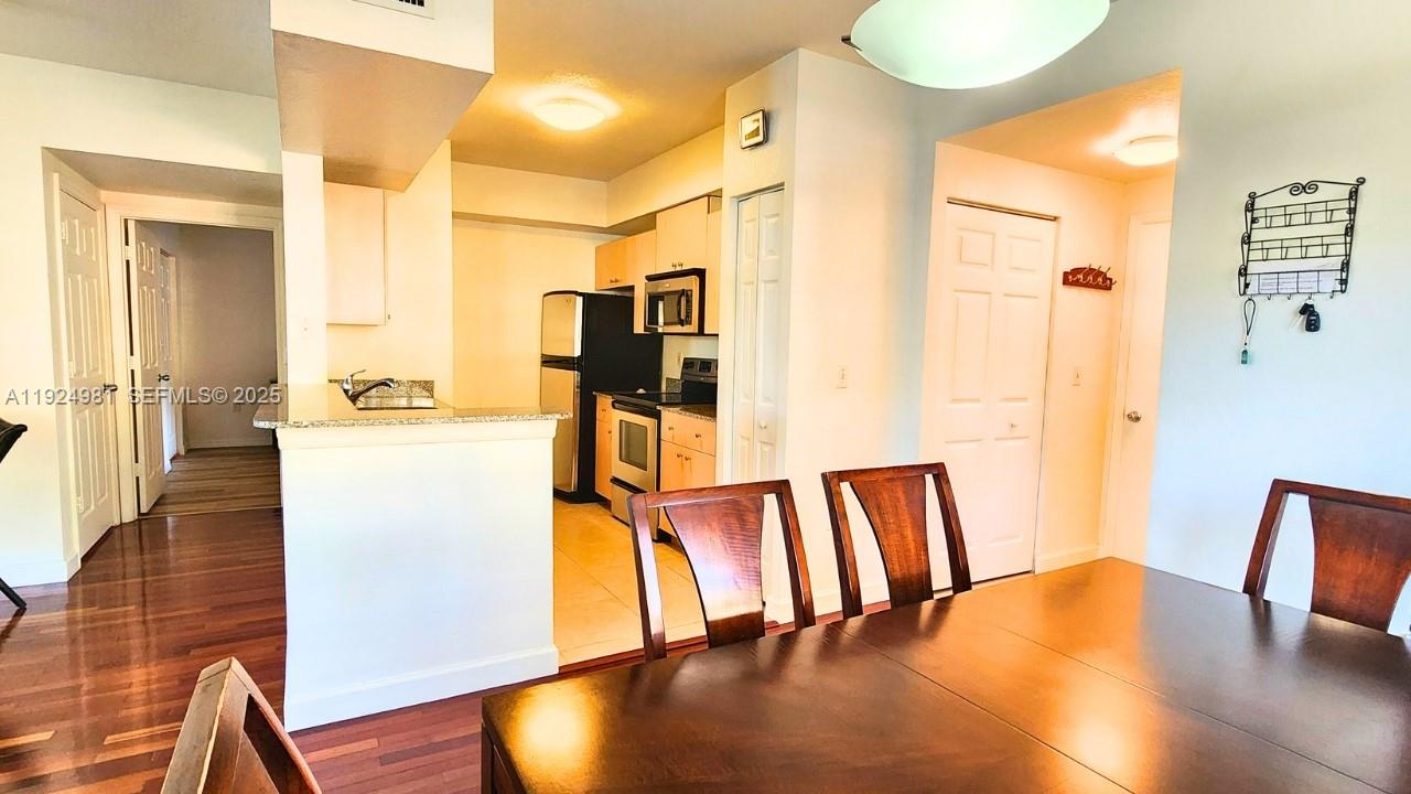 2557 Centergate Drive, Unit 101 Miramar, FL 33025 - Photo 6 of 14 a view of kitchen with furniture and wooden floor