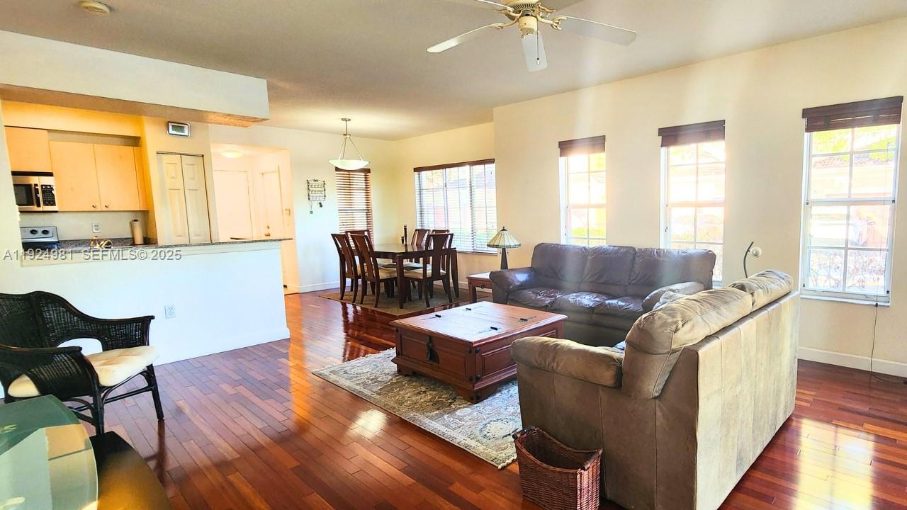 2557 Centergate Drive, Unit 101 Miramar, FL 33025 - Photo 9 of 14 a living room with furniture and wooden floor