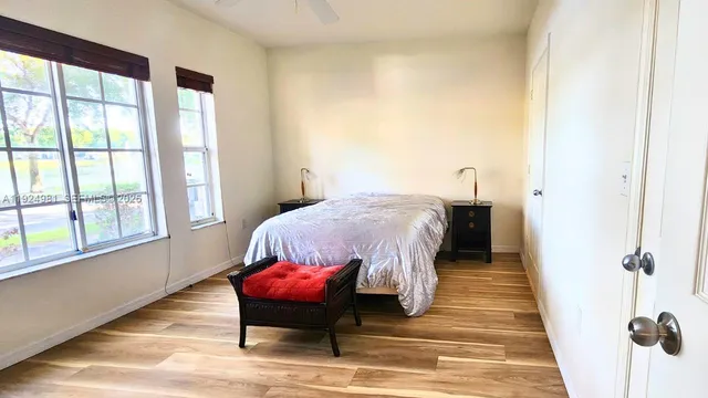 a bedroom with a bed and wooden floor