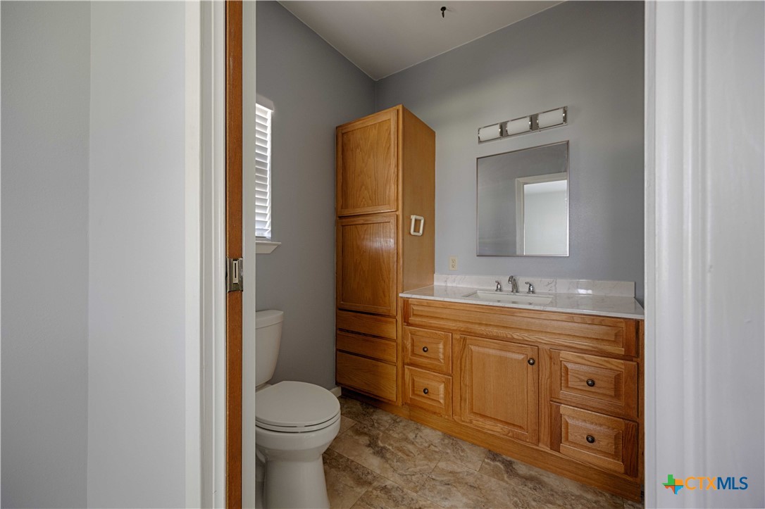 3814 Maeker Road Flatonia, TX 78941 - Photo 13 of 28 a bathroom with a toilet sink and mirror