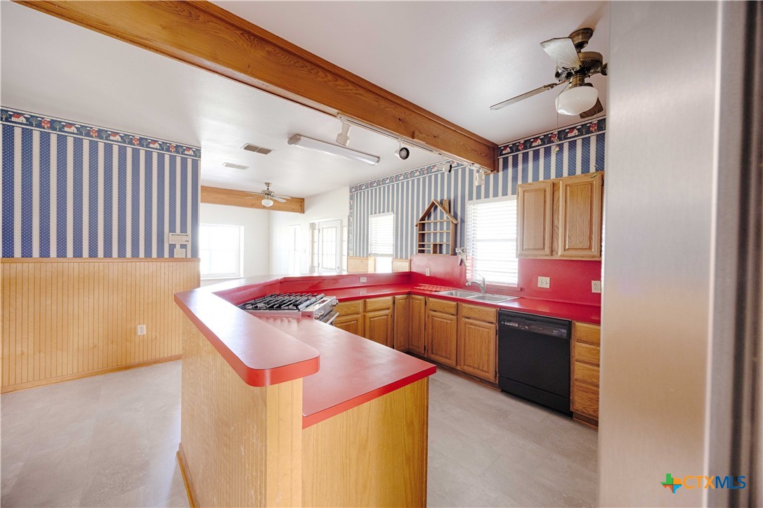 3814 Maeker Road Flatonia, TX 78941 - Photo 6 of 28 a kitchen with stainless steel appliances granite countertop a sink and a microwave