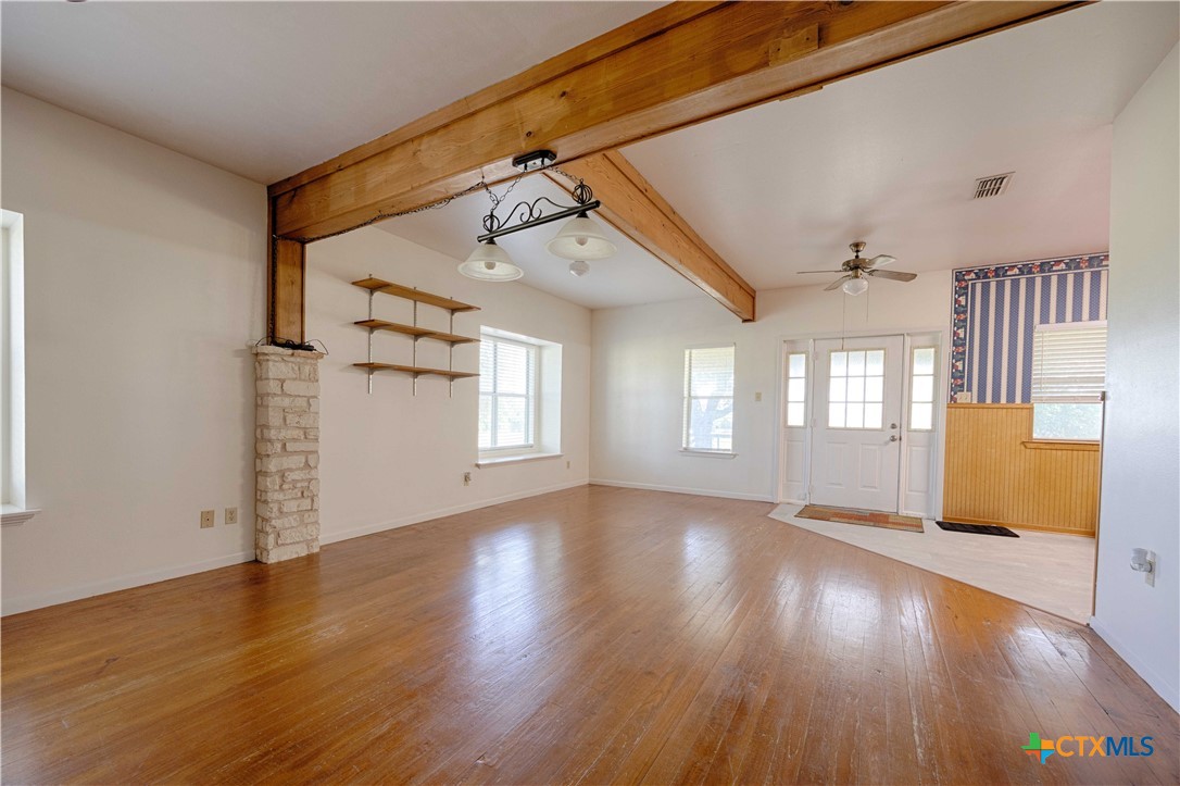 3814 Maeker Road Flatonia, TX 78941 - Photo 7 of 28 a view of an empty room with wooden floor and a window