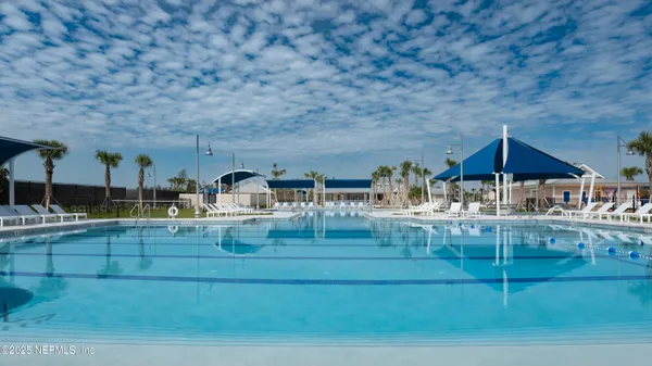 a view of swimming pool with outdoor seating and city view