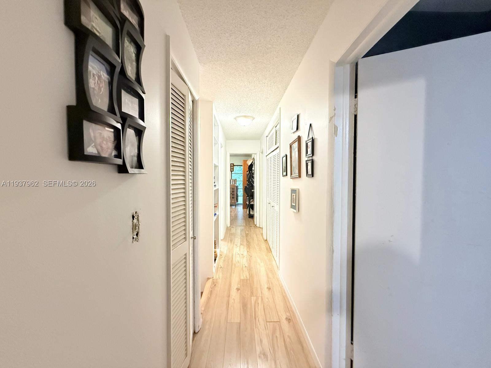 3330 Atlanta Street, Unit 14C Hollywood, FL 33021 - Photo 13 of 15 a view of a hallway with wooden floor and dining room