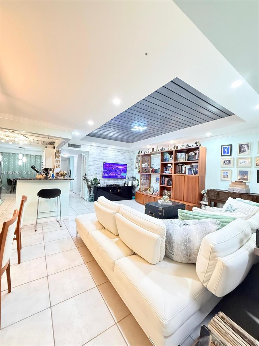 3330 Atlanta Street, Unit 14C Hollywood, FL 33021 - Photo 15 of 15 a living room with furniture and a flat screen tv