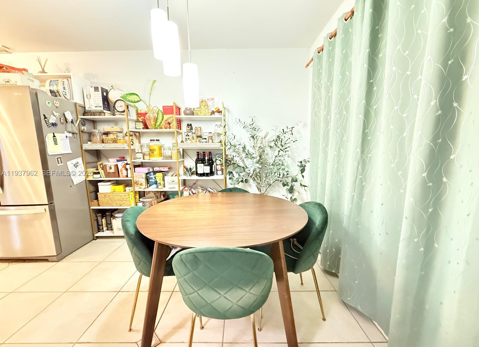 3330 Atlanta Street, Unit 14C Hollywood, FL 33021 - Photo 3 of 15 a balcony with table and chairs