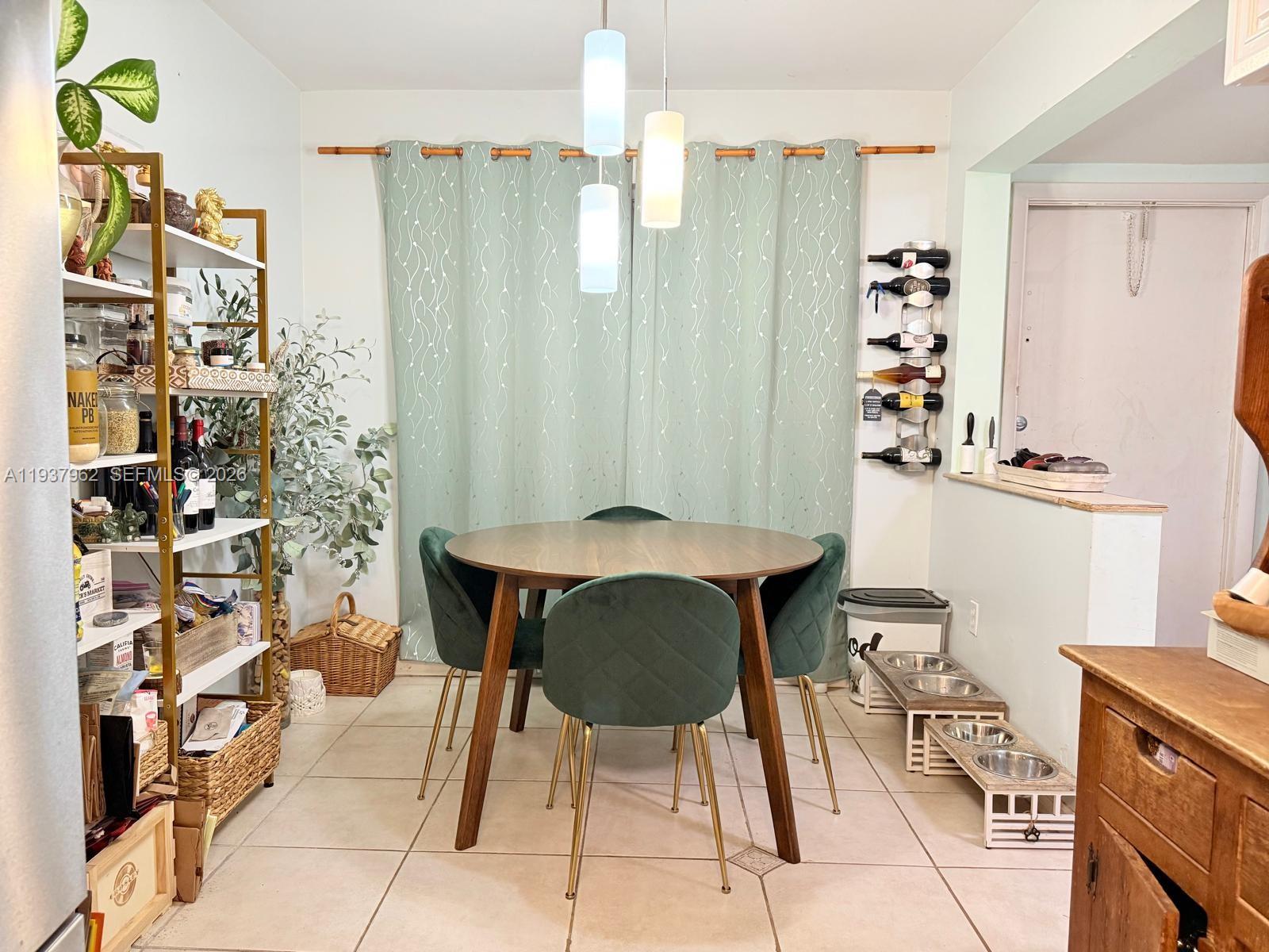 3330 Atlanta Street, Unit 14C Hollywood, FL 33021 - Photo 6 of 15 a view of a dining room with furniture and chandelier
