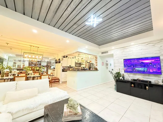 a living room with granite countertop furniture and a kitchen view