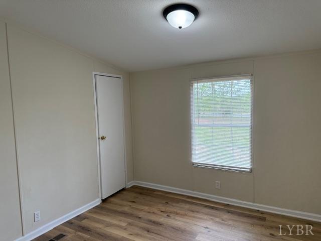 3112 Red House Road Appomattox, VA 24522 - Photo 12 of 14 an empty room with wooden floor and windows