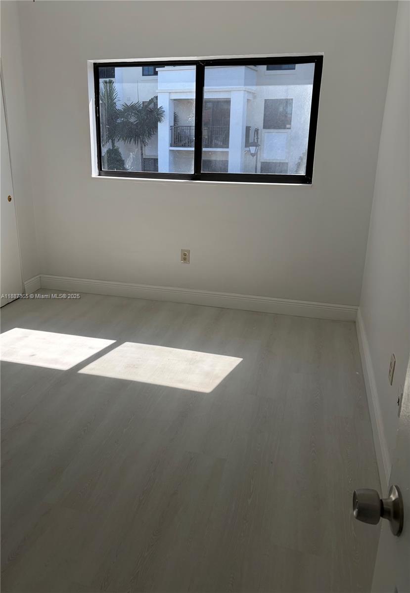 220 Southwest 7th Street, Unit 8 Boca Raton, FL 33432 - Photo 12 of 14 a view of wooden floor and entryway