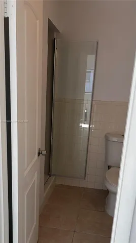 an empty room with an entrance to other room