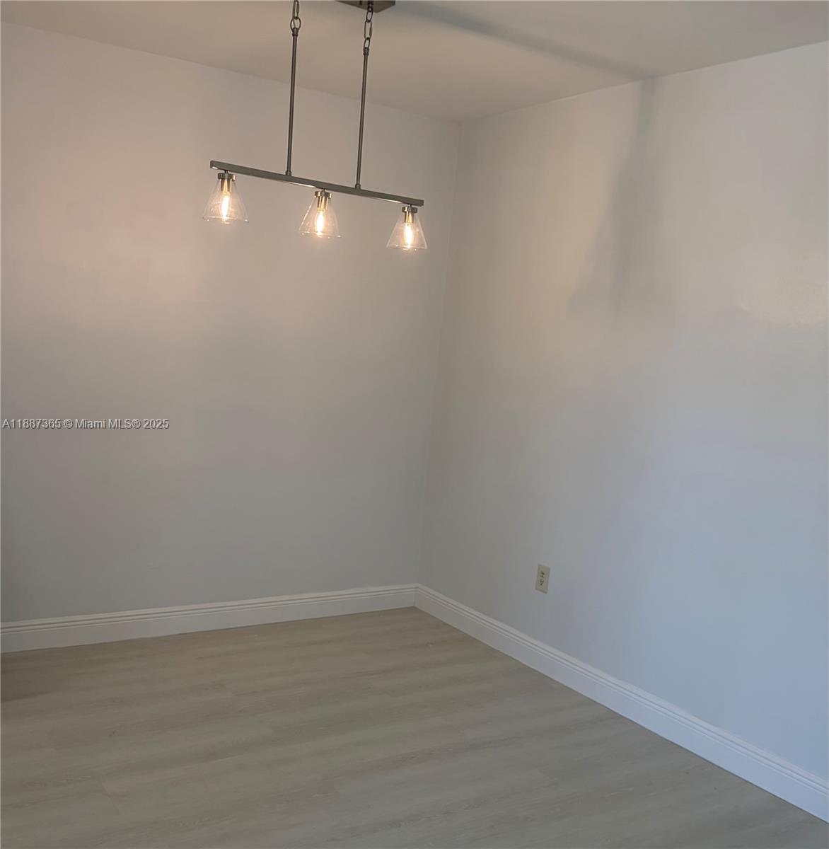 220 Southwest 7th Street, Unit 8 Boca Raton, FL 33432 - Photo 6 of 14 a view of an empty room with chandelier fan