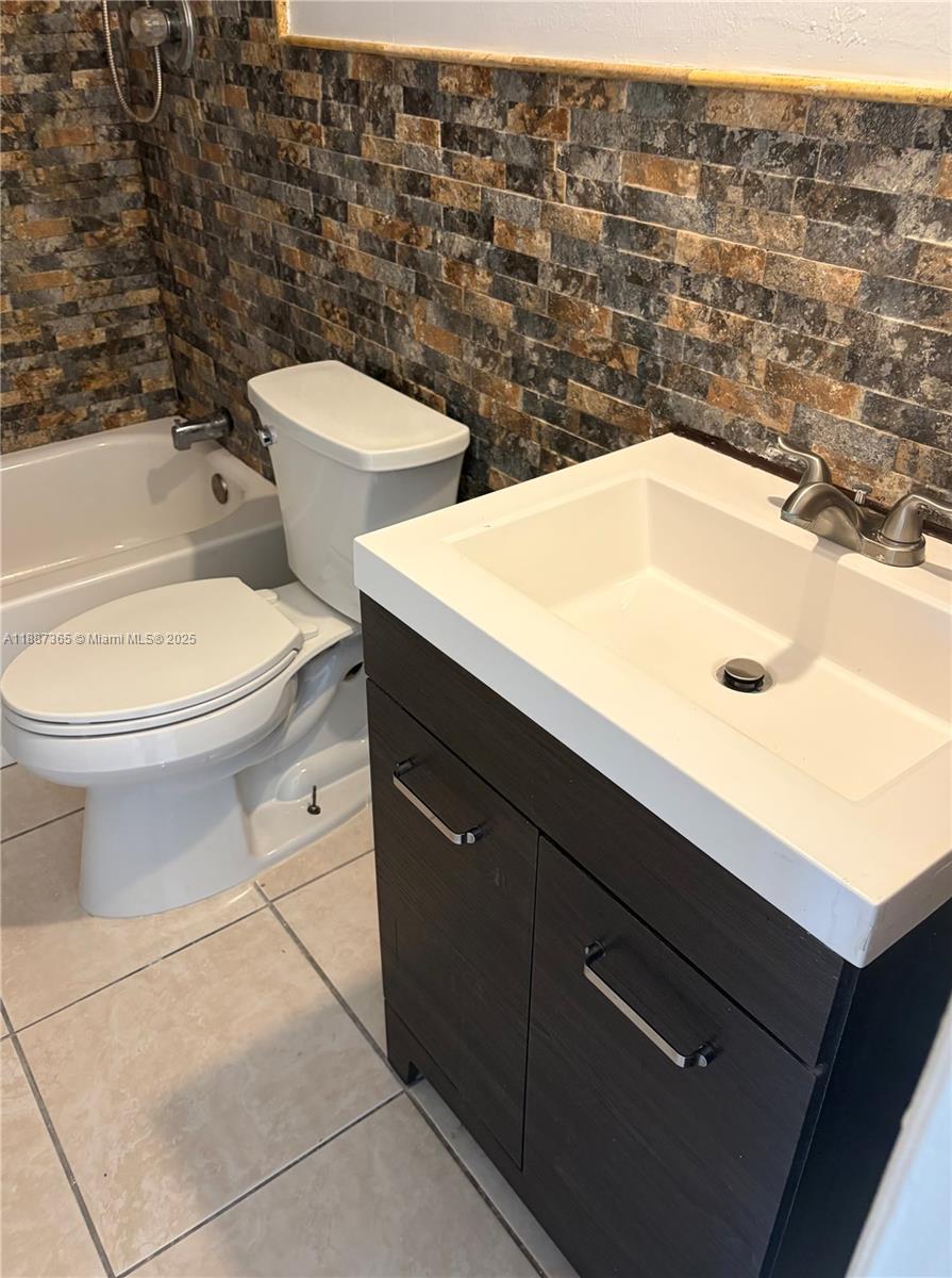 220 Southwest 7th Street, Unit 8 Boca Raton, FL 33432 - Photo 8 of 14 a bathroom with a toilet sink and mirror