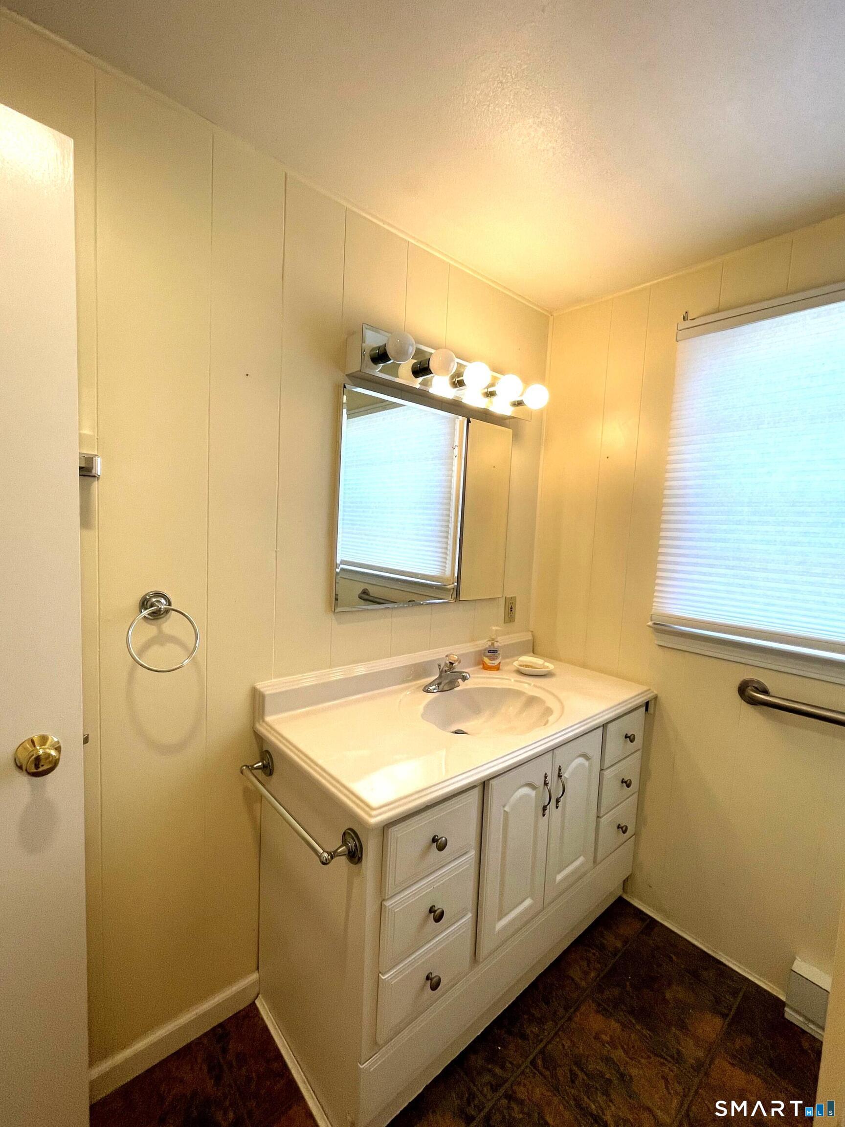 18 Old South Cove Road Old Saybrook, CT 06475 - Photo 39 of 40 a bathroom with a granite countertop sink and a mirror