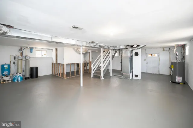 a view of a room with wooden floor and windows