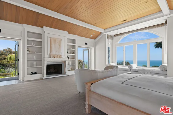 a large white kitchen with a large window