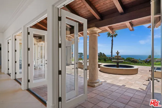a dining room with furniture and a large window