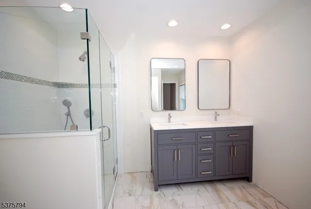 a bathroom with a double vanity sink and mirror