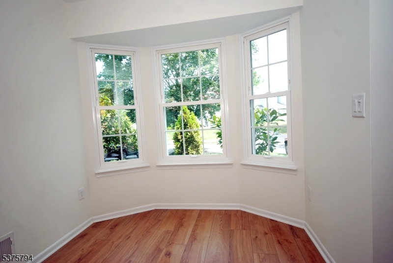 23 Buffalo Hollow Road Somerville, NJ 08876 - Photo 4 of 12 an empty room with wooden floor and windows