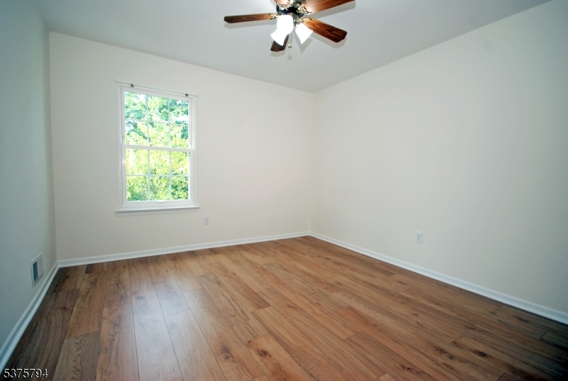 23 Buffalo Hollow Road Somerville, NJ 08876 - Photo 6 of 12 a view of an empty room with wooden floor and a window