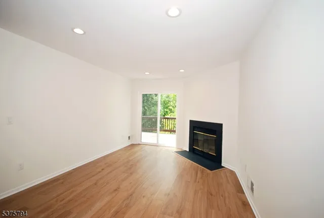 wooden floor in an empty room with a fireplace