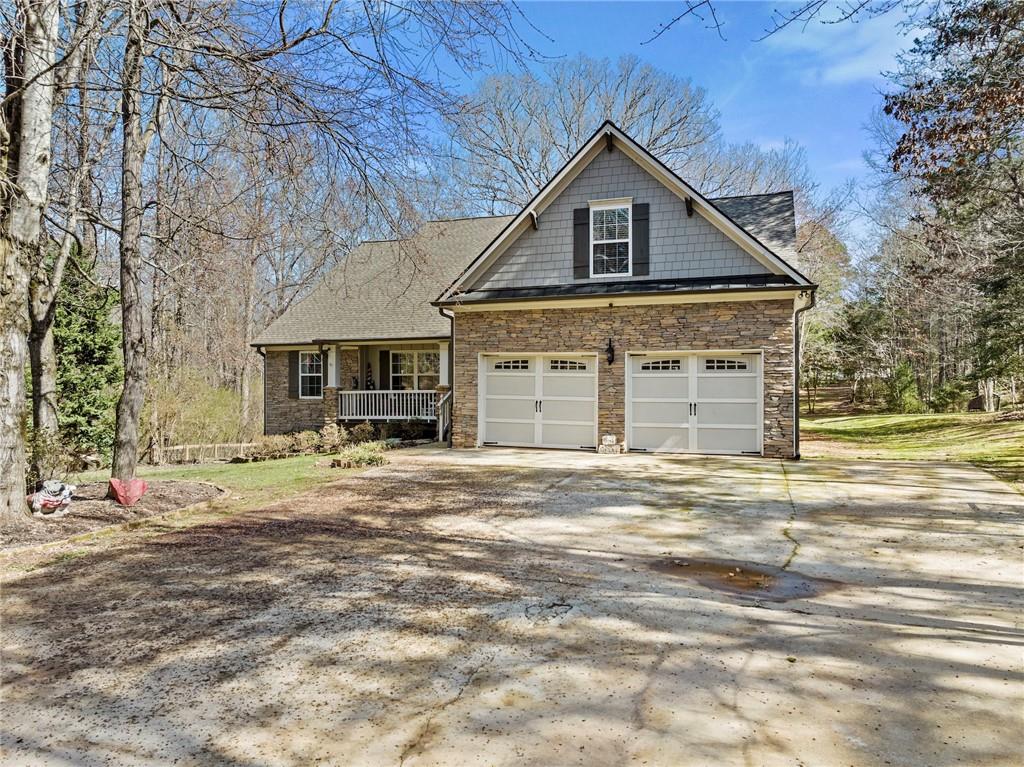 6234 Lula Road Lula, GA 30554 - Photo 1 of 1 a front view of a house with a garden