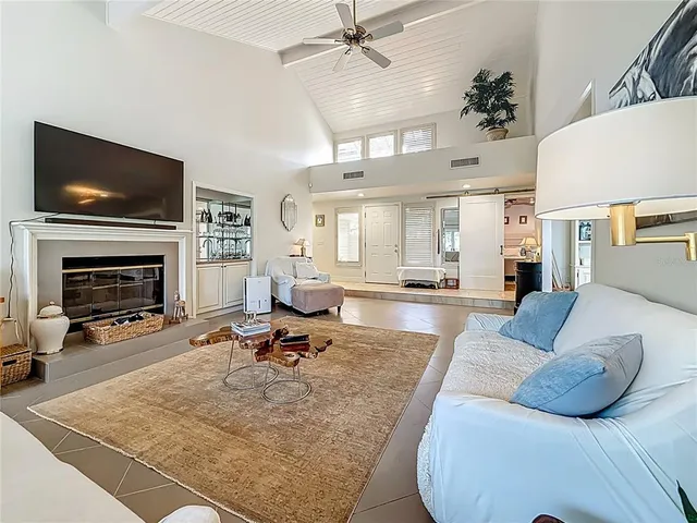a living room with stainless steel appliances kitchen island granite countertop furniture and a view of kitchen