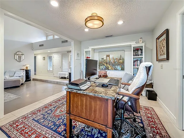 a kitchen with granite countertop white cabinets and white stainless steel appliances