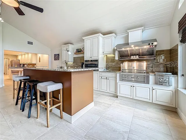 a spacious bathroom with a granite countertop sink a toilet and a mirror