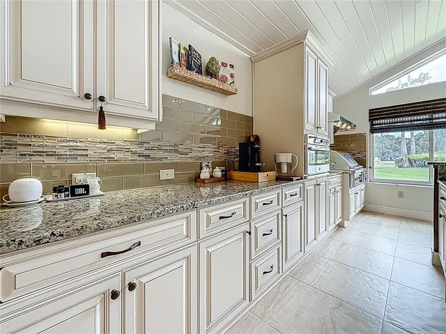 a bedroom with a bed and dresser with wooden floor