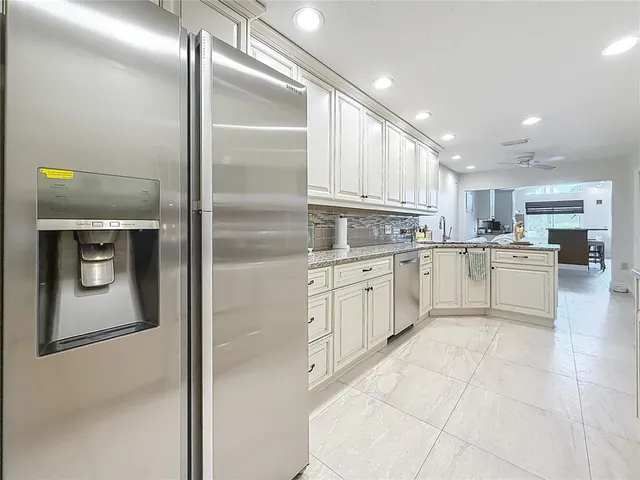 a bedroom with furniture and large windows