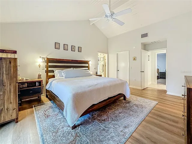 an aerial view of residential houses with outdoor space and trees all around