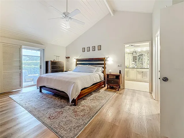 an aerial view of residential houses with outdoor space and trees all around