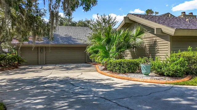 a house that has a tree in front of it