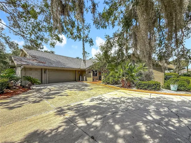a view of a house with a yard and pathway